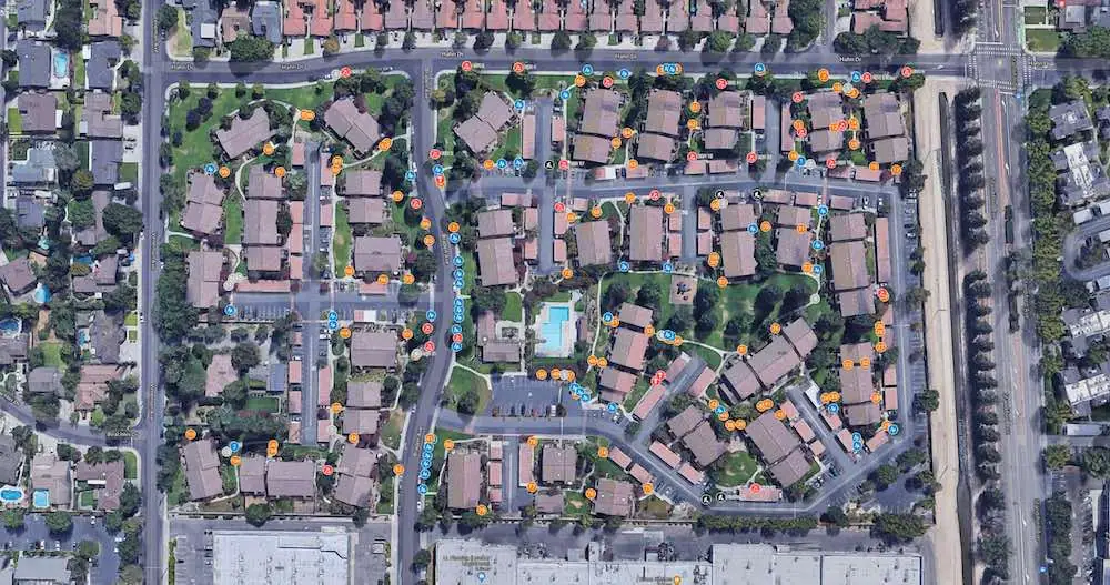 Grinding work map: a residential community from above with a GPS pin at every area that needs work
